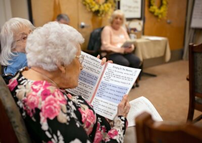 elderly woman singing from hymnal