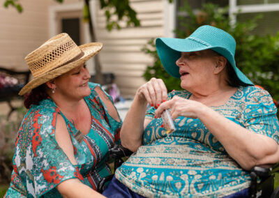 smiling women wearing fancy hats