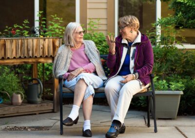 laughing women seated on a patio