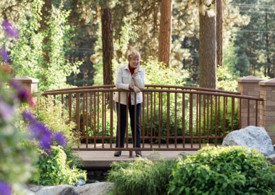 laughing woman standing on garden bridge