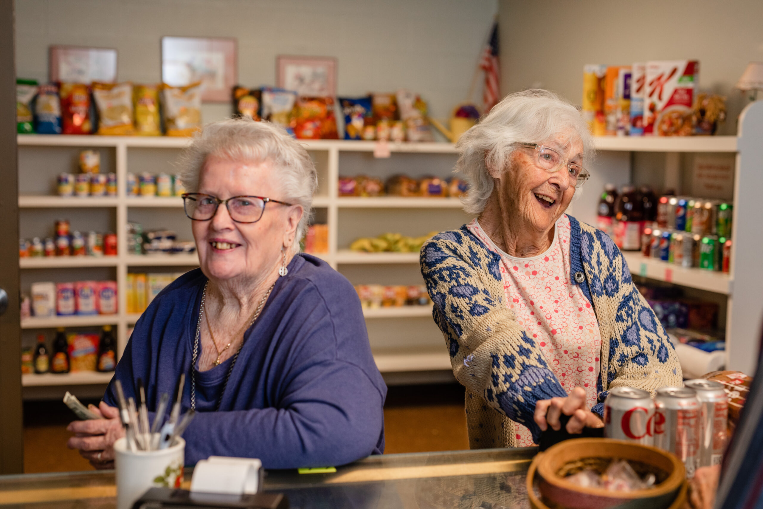 two ladies working at grocery counter