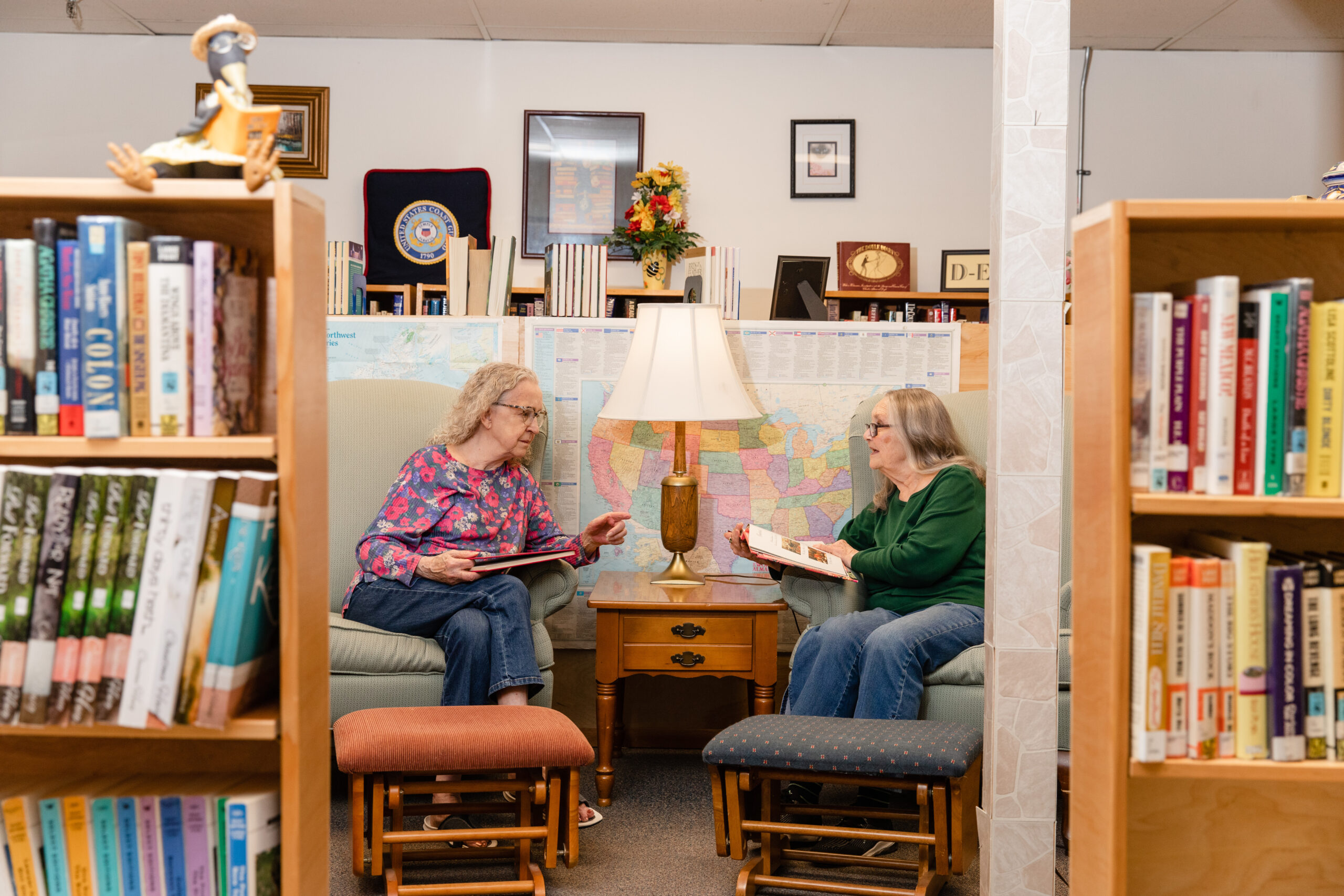 two women having a spirited conversation in a library