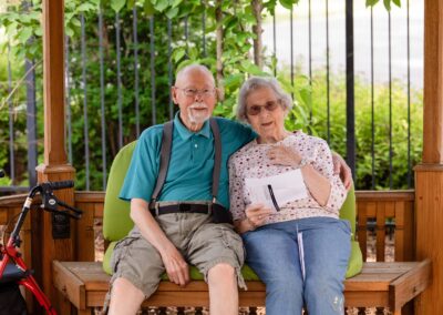 elderly couple arm-in-arm on a bench