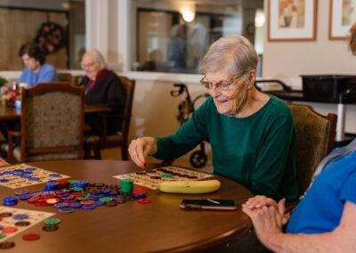 smiling elderly woman playing bingo