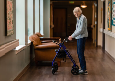 smiling elderly woman using a walker