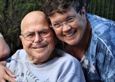 care giver with arm around elderly man